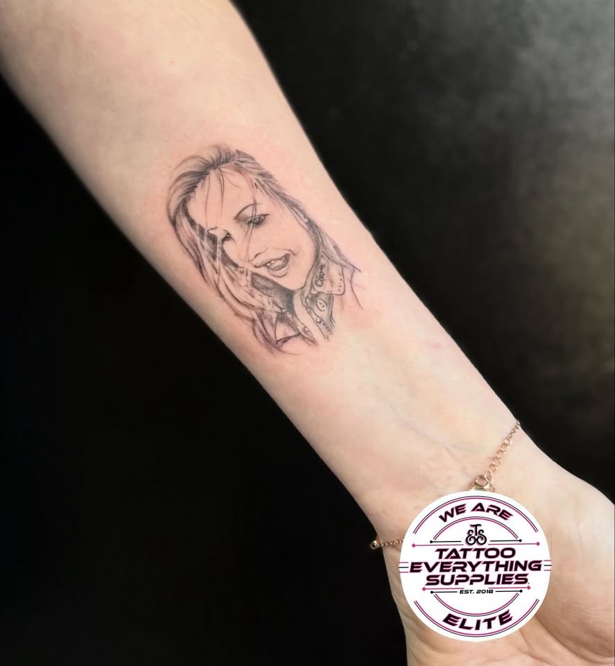 Fine line portrait tattoo on forearm
