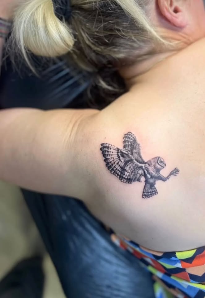 Barn owl in flight tattoo on shoulder