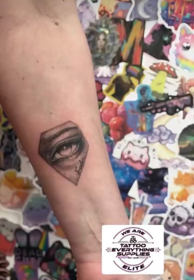 Geometric eye tattoo on forearm